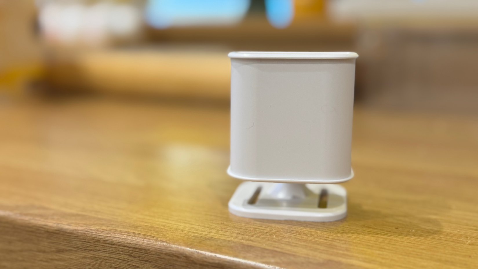 An Everything Presence Lite mmwave presence detector standing on a work surface.