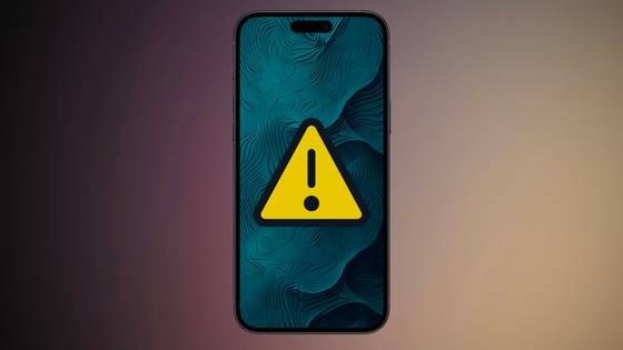 An iPhone with a caution icon in the middle of it, in front of a colorful background.