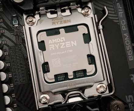 A close-up photo of the AMD Ryzen 7 7700 CPU in the AM5 socket and the ASRock B650M PG RIptide motherboard.