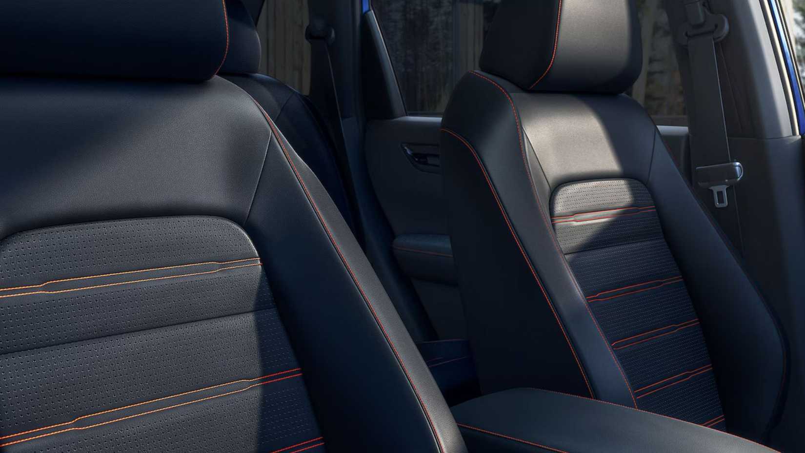 Close up of black leather seats with orange stitching in a Honda CR-V Hybrid.