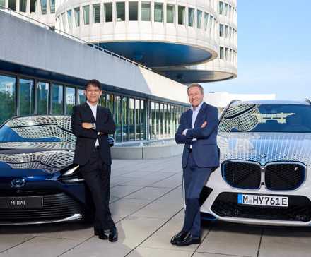 Toyota and BMW Presidents posing by their next-gen FCEVs
