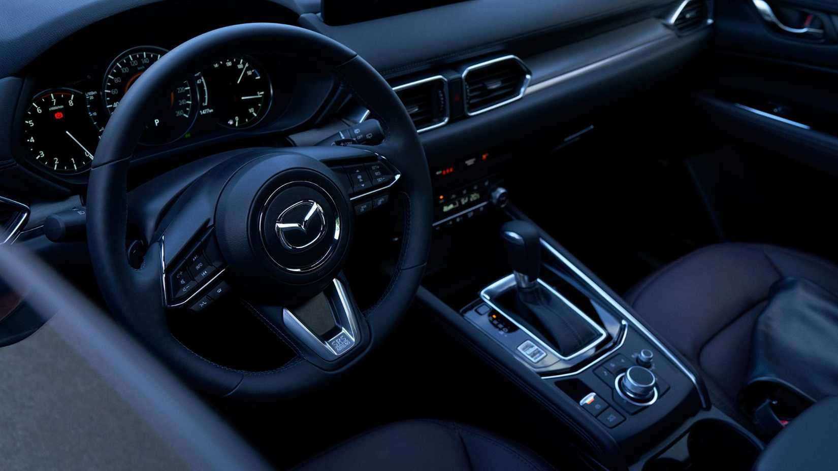 Close-up of 2025 Mazda CX-5 steering wheel and transmission.