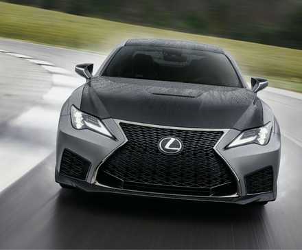 Front view of a gray 2023 Lexus RC F Track Edition on a wet racetrack.