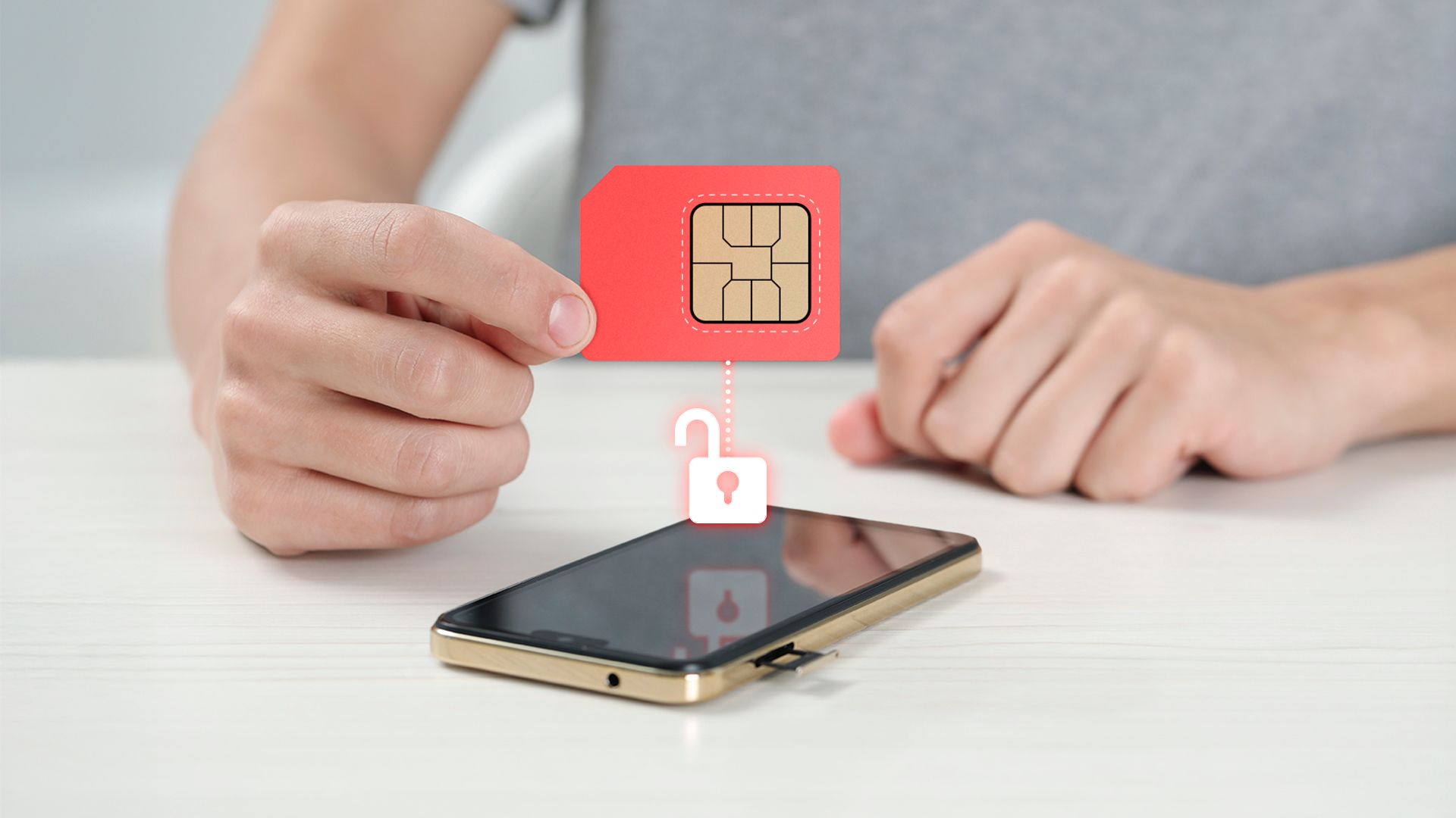 A hand holding a SIM card above a phone with an unlocked icon.