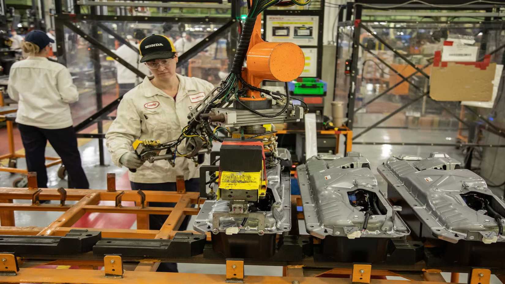 Honda hybrid battery being constructed by a female worker at the automaker