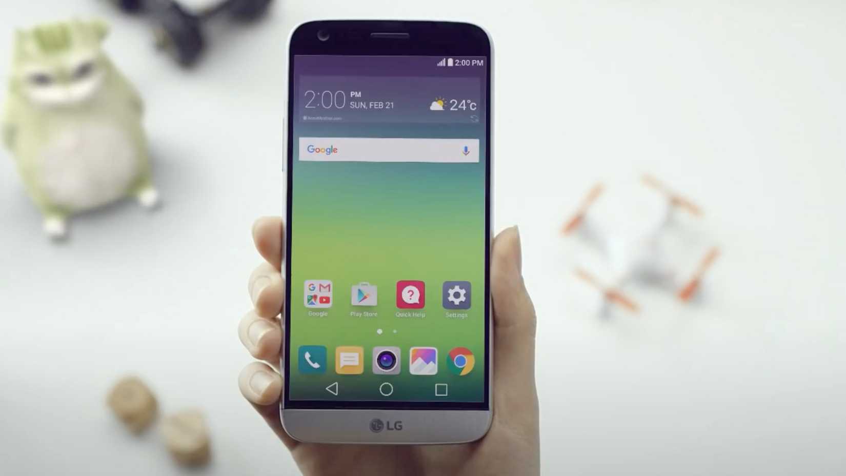 A hand holding the LG G5 phone.