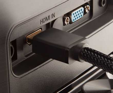 An HDMI cable plugged into the back of a monitor.