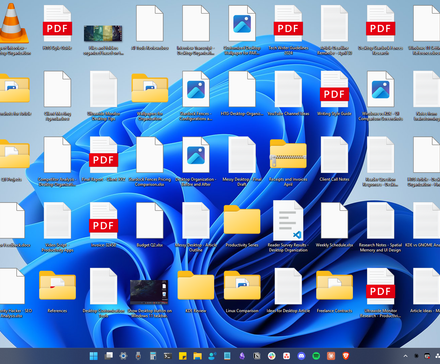 A messy Windows 11 desktop polluted with random files and folders.