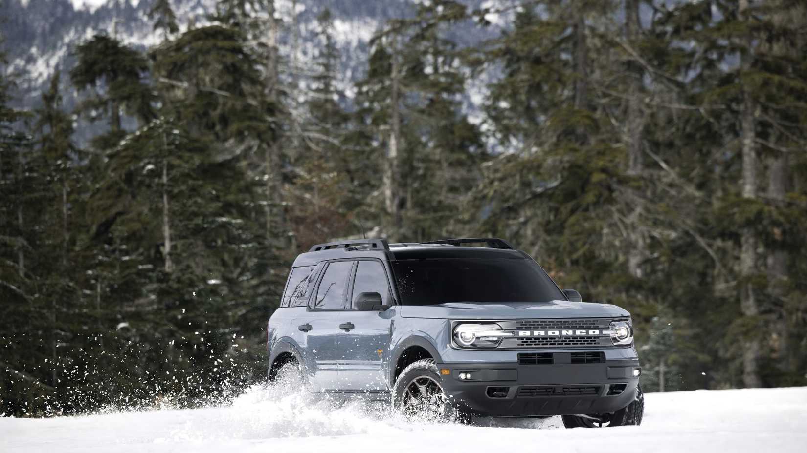 Front 3/4 view of a gray 2022 Ford Bronco Sport off-roading in the snow.