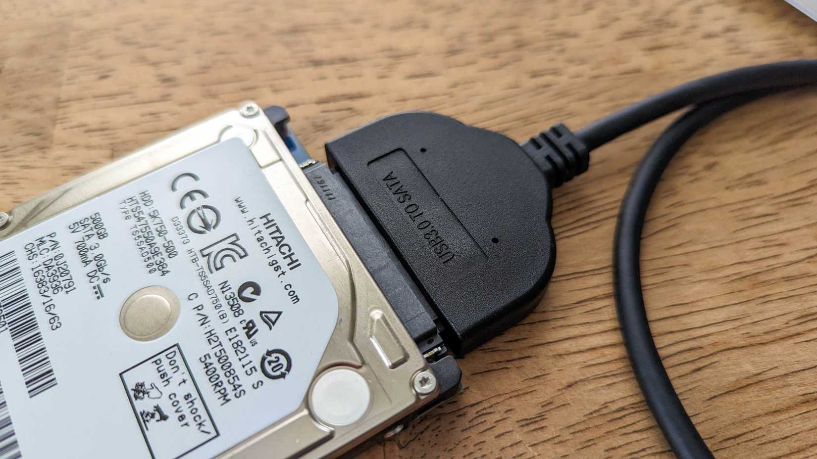 A laptop hard drive attached to a USB to SATA adapter. 