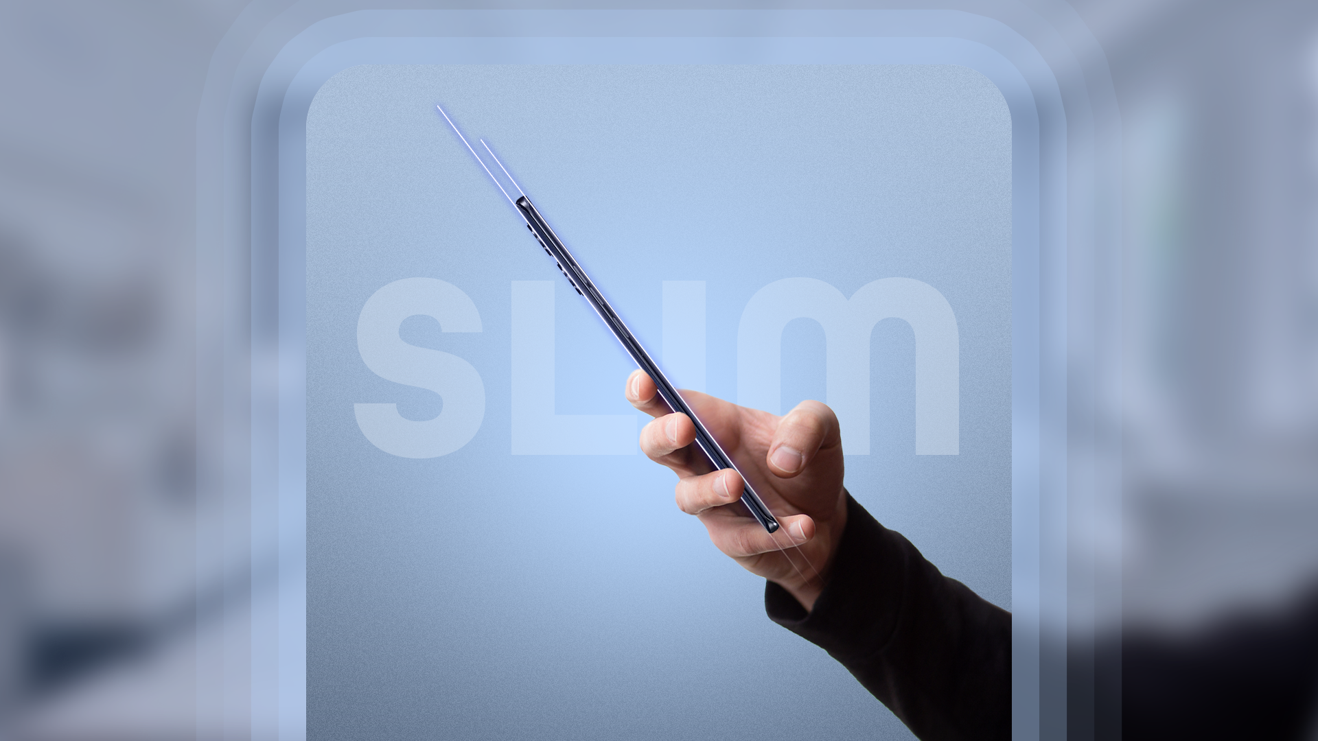 A hand holding a slim phone.