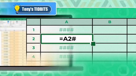 An Excel spreadsheet with '=A2#' written on it and a blurred laptop in the background.