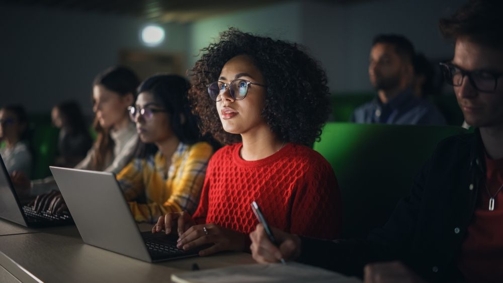 A woman sitting in with her laptop.