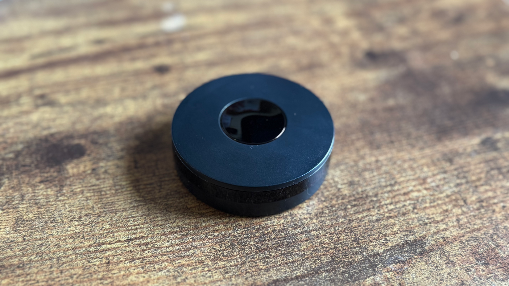 Tuya Wi-Fi IR Blaster on a wooden desk.