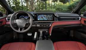 Shot of the cabin of a 2026 Toyota Camry XSE AWD with red leather shwoing the steering wheel and infotainment display.