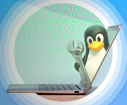 A laptop on a desk seen from the side, with the Linux mascot coming out of the screen holding a wrench.
