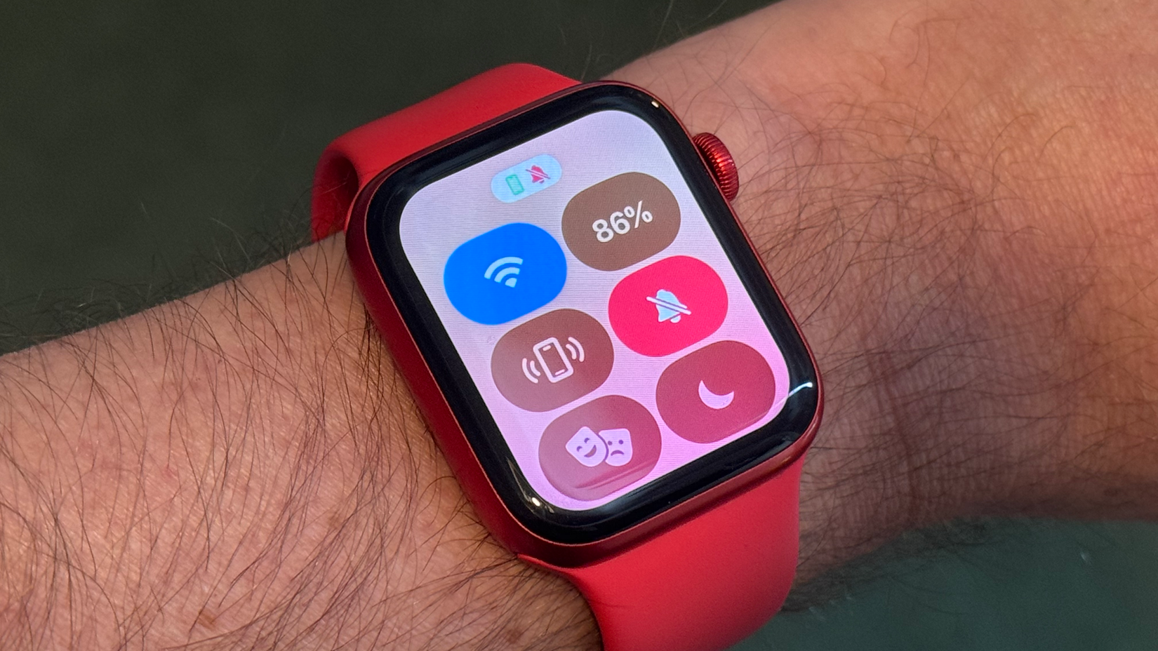 An Apple Watch displaying the Control Center being worn on a wrist.