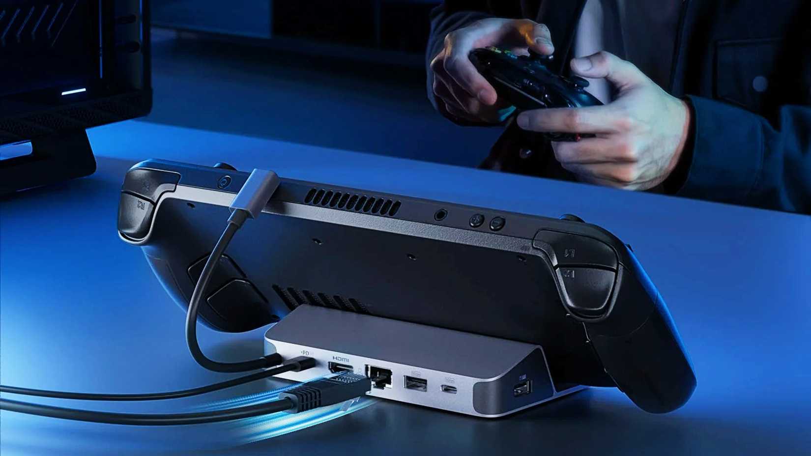 Anker 6-in-1 USB-C hub with a Steam Deck on a desk with someone playing on a controller nearby
