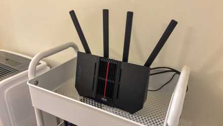 Entire-home stressed networks are a rip-off—this is the only Ethernet run that in reality issues An ASUS router on a shelf.