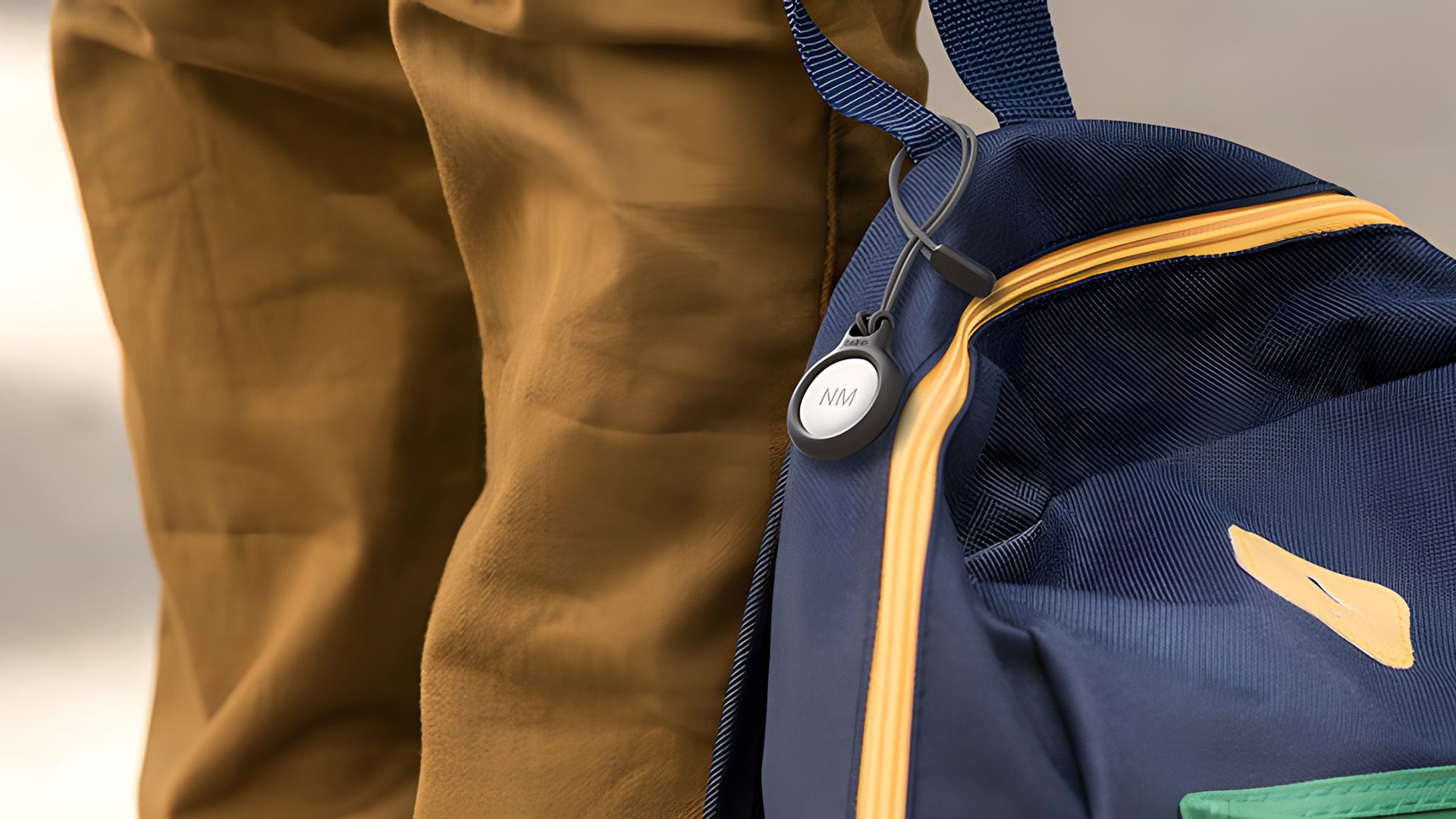 AirTag in carrying case on a backpack.