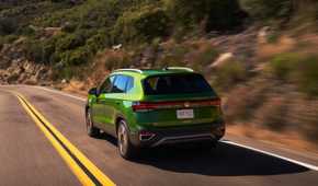 Rear 3/4 action shot of a 2025 Volkswagen Taos