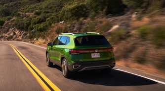 Rear 3/4 action shot of a 2025 Volkswagen Taos