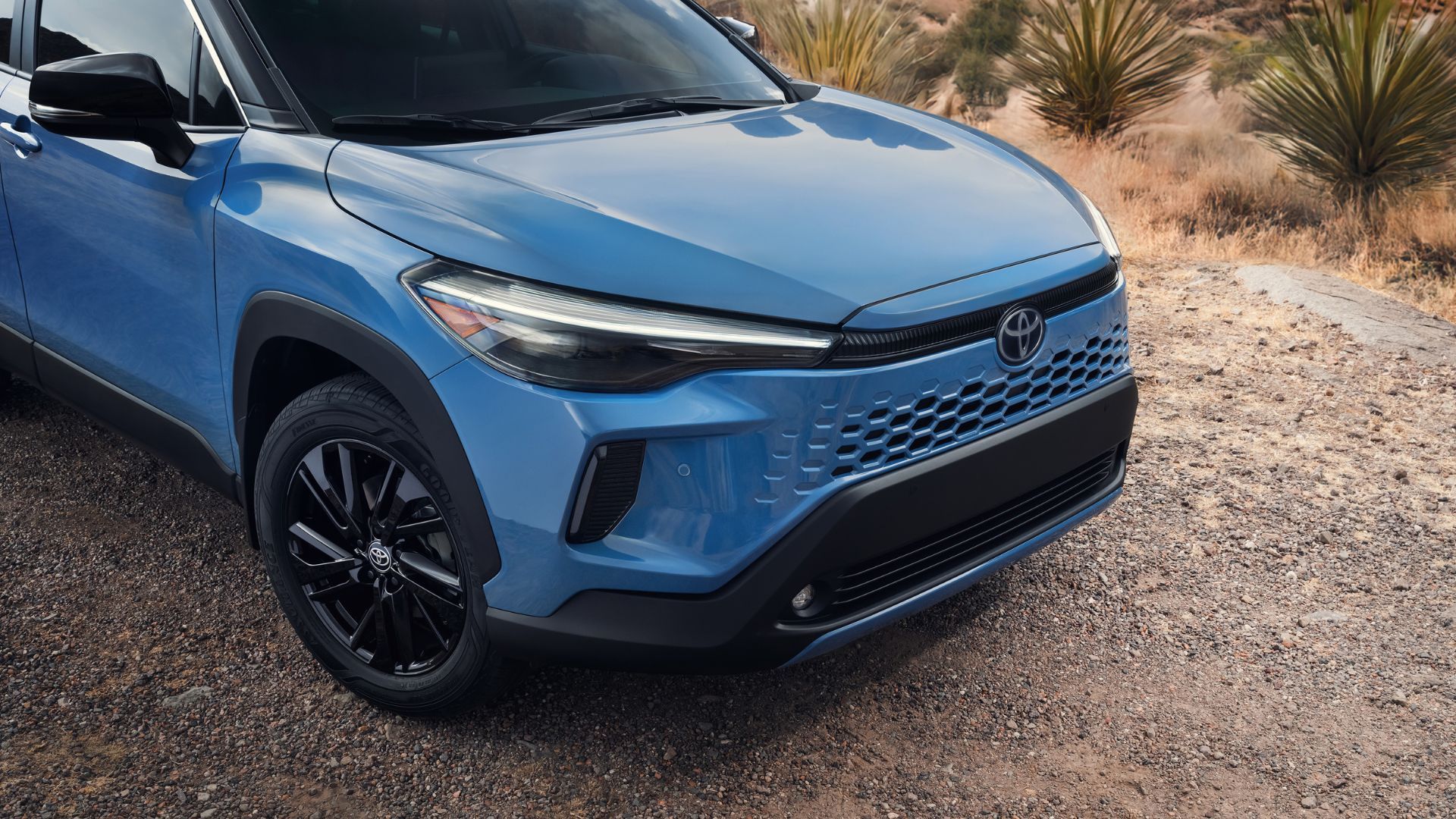 Close-up shot of the front end of a blue 2026 Toyota Corolla Cross.