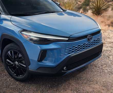 Close-up shot of the front end of a blue 2026 Toyota Corolla Cross.