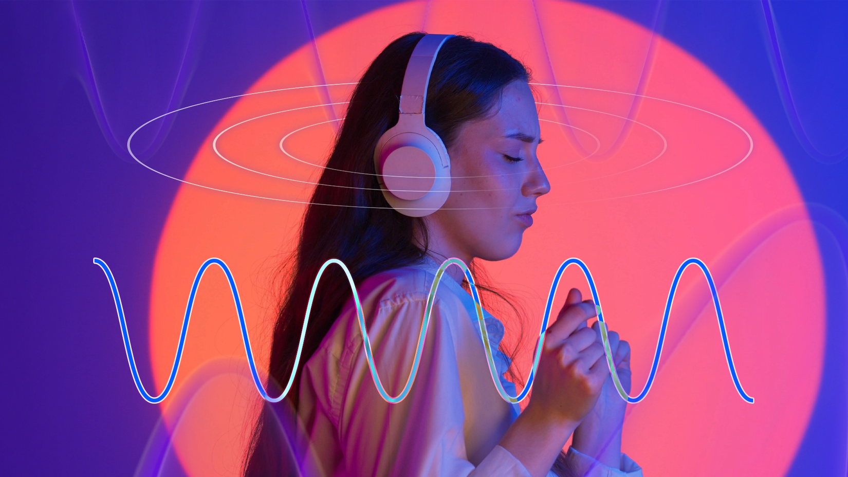 Woman wearing headphones with sound waves around her.