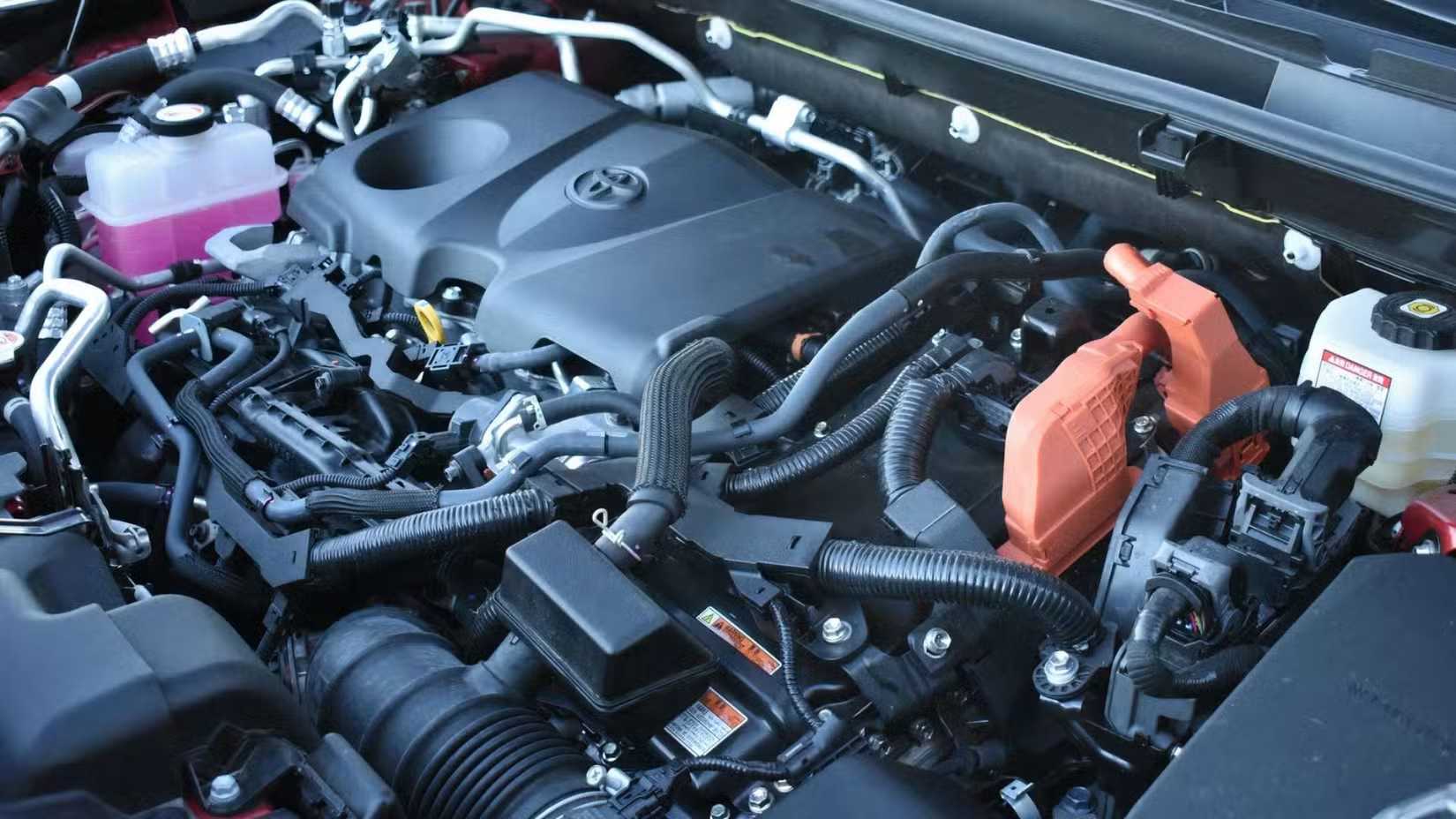 Close-up shot under the hood of a 2023 Toyota RAV4 Prime, showing the 2.5-liter four-cylinder plug-in hybrid engine.