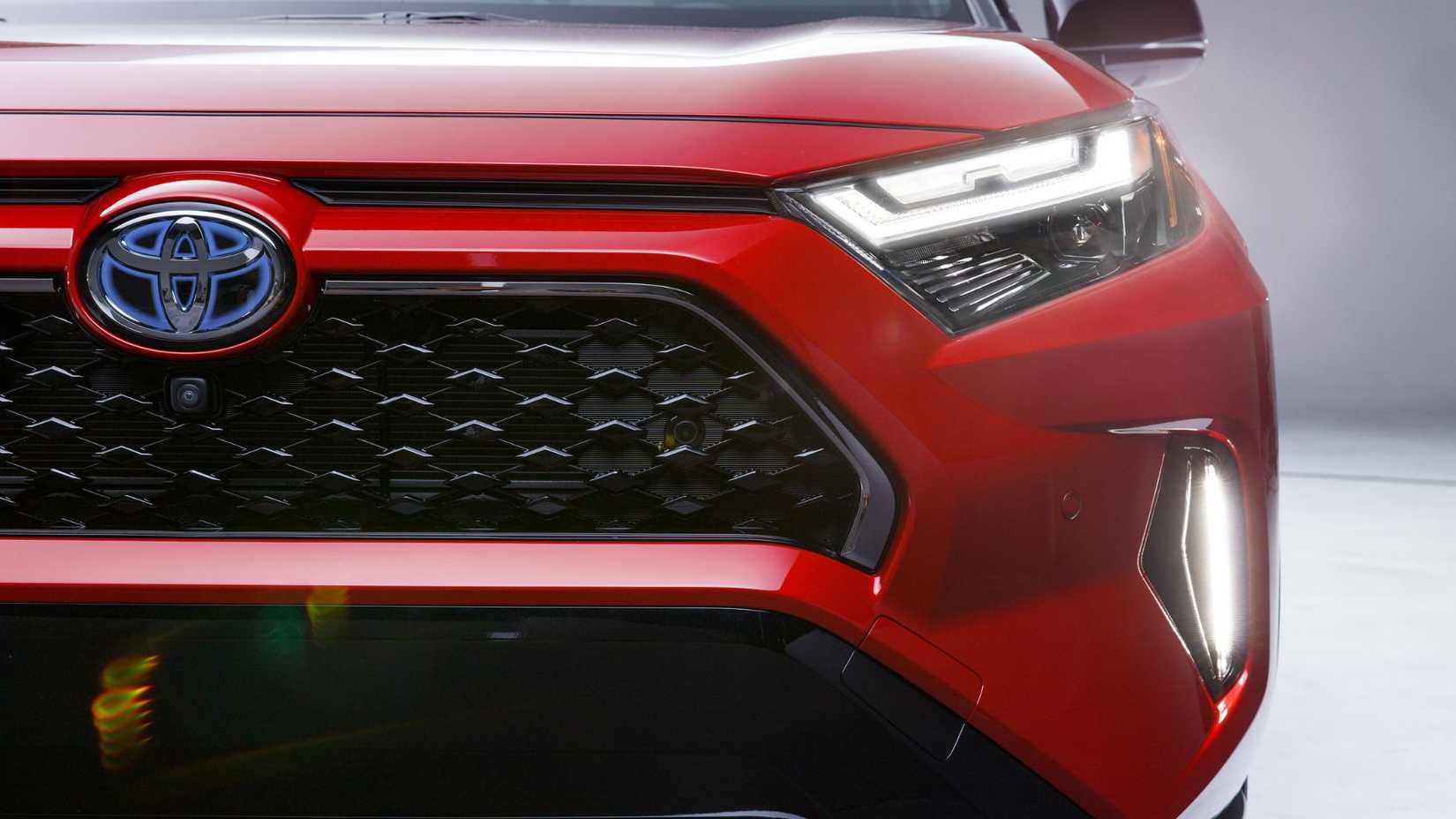 Close-up shot of the front end of a red 2024 Toyota RAV4 Prime XSE.