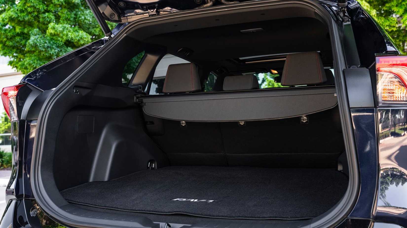 Close-up showing the inside of the trunk of a blue 2024 Toyota RAV4 Prime XSE.