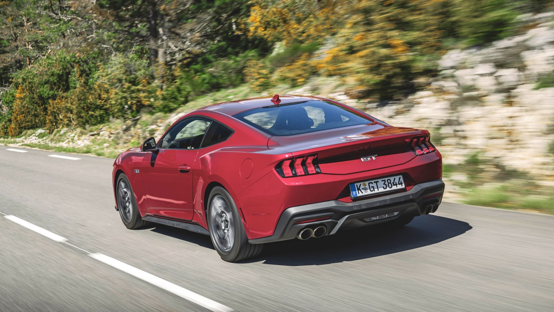 Rear 3/4 action shot of a 2024 Ford Mustang