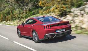 Rear 3/4 action shot of a 2024 Ford Mustang