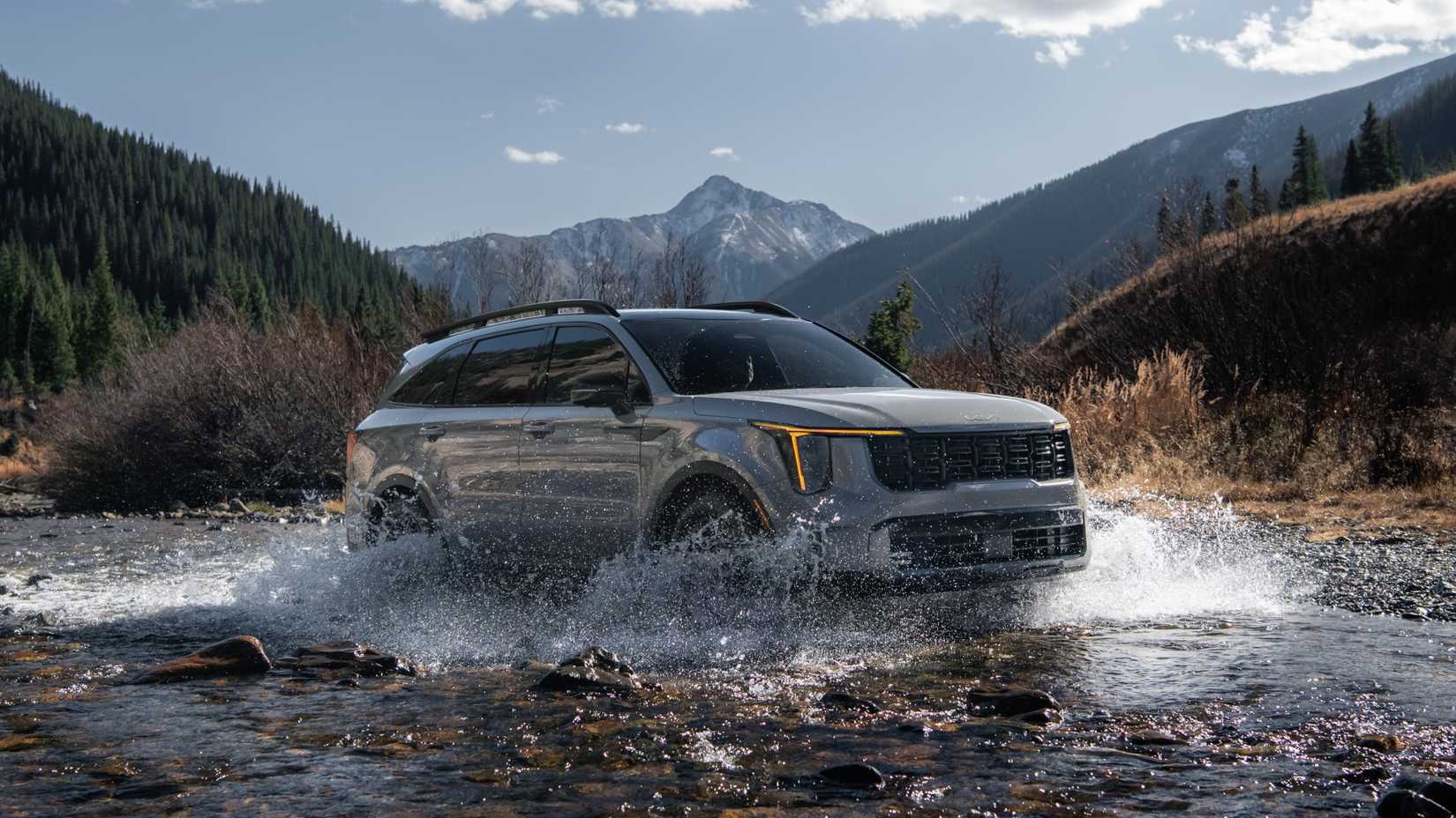 Front 3/4 action shot of a 2024 Kia Sorento wading through a river