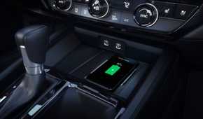 Close-up shot of the wireless charger in a 2023 Honda Accord Touring with a smartphone charging.