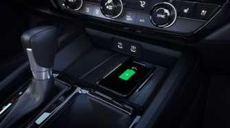 Close-up shot of the wireless charger in a 2023 Honda Accord Touring with a smartphone charging.