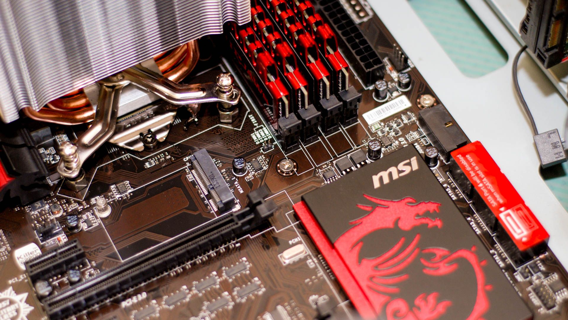 An MSI motherboard with an M.2 slot and a PCIe slot visible. 