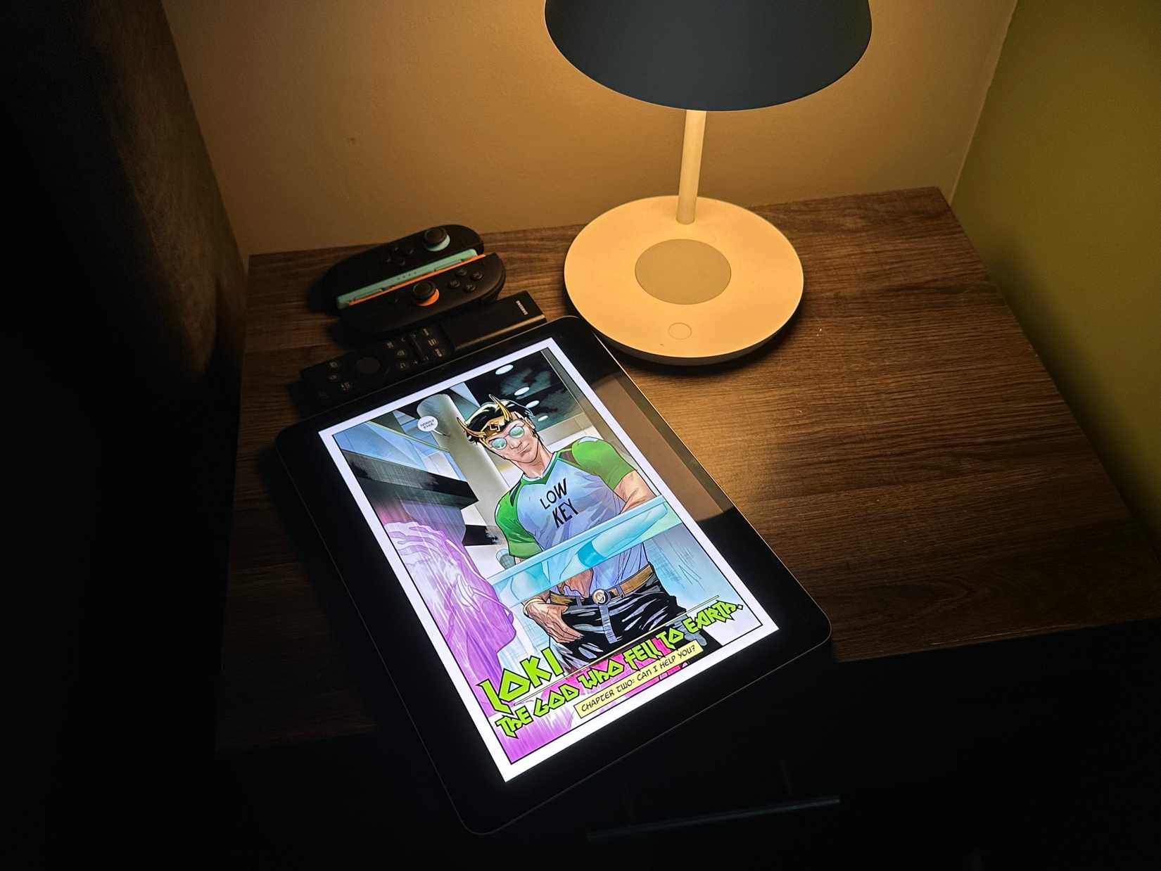 An iPad with a Loki comic from Marvel Unlimited on a bedside table.