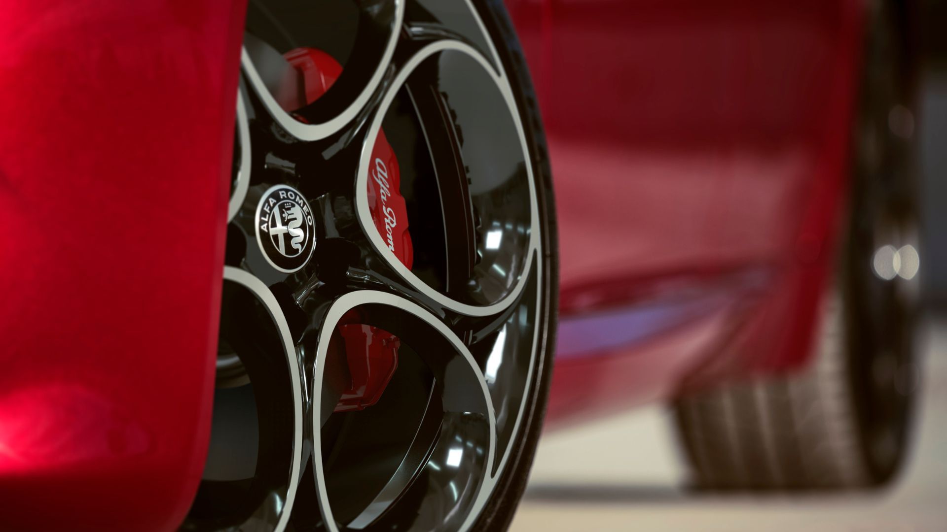 Close-up of the alloy wheel on a red 2022 Alfa Romeo Giulia.