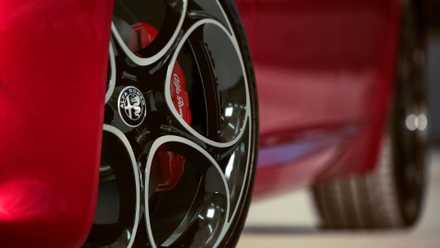 Close-up shot of the alloy wheel on a red 2022 Alfa Romeo Giulia.