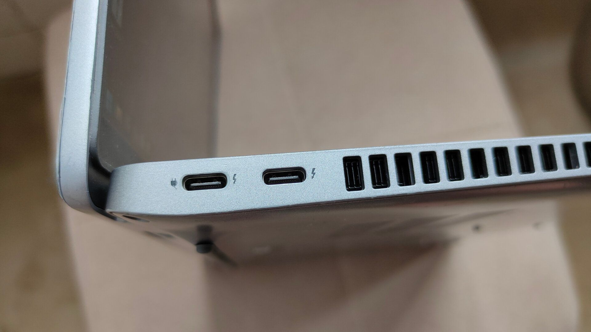 A close-up of two USB-C Thunderbolt 4 ports on a laptop.