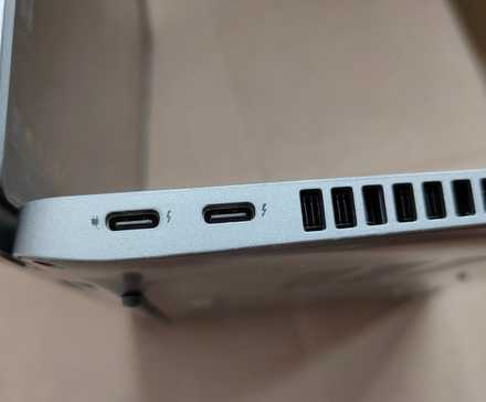 A close-up of two USB-C Thunderbolt 4 ports on a laptop.