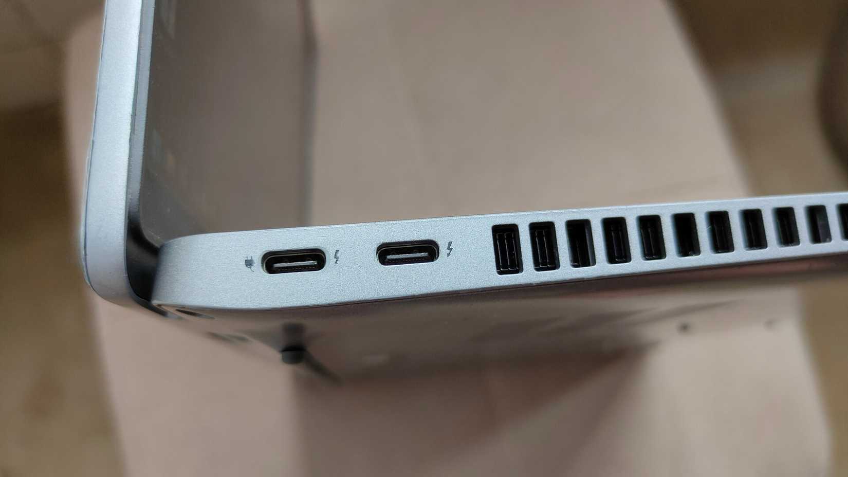 A close-up of two USB-C Thunderbolt 4 ports on a laptop.