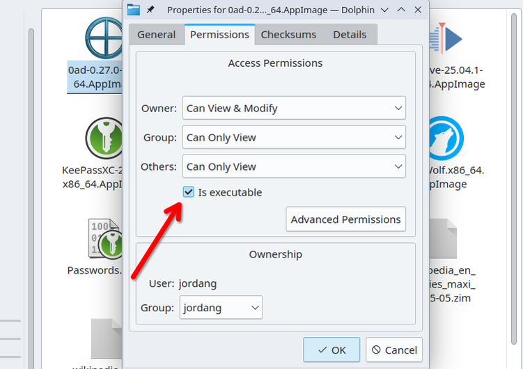 The Dolphin browser permission management dialog, with a red arrow pointing to the 'Is executable' checkbox.