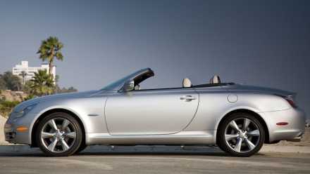 Static side profile shot of a silver 2010 Lexus SC 430 parked on a beach.
