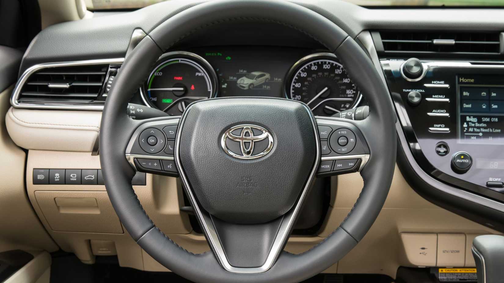 Close-up of the steering wheel of a 2020 Toyota Camry XLE Hybrid.