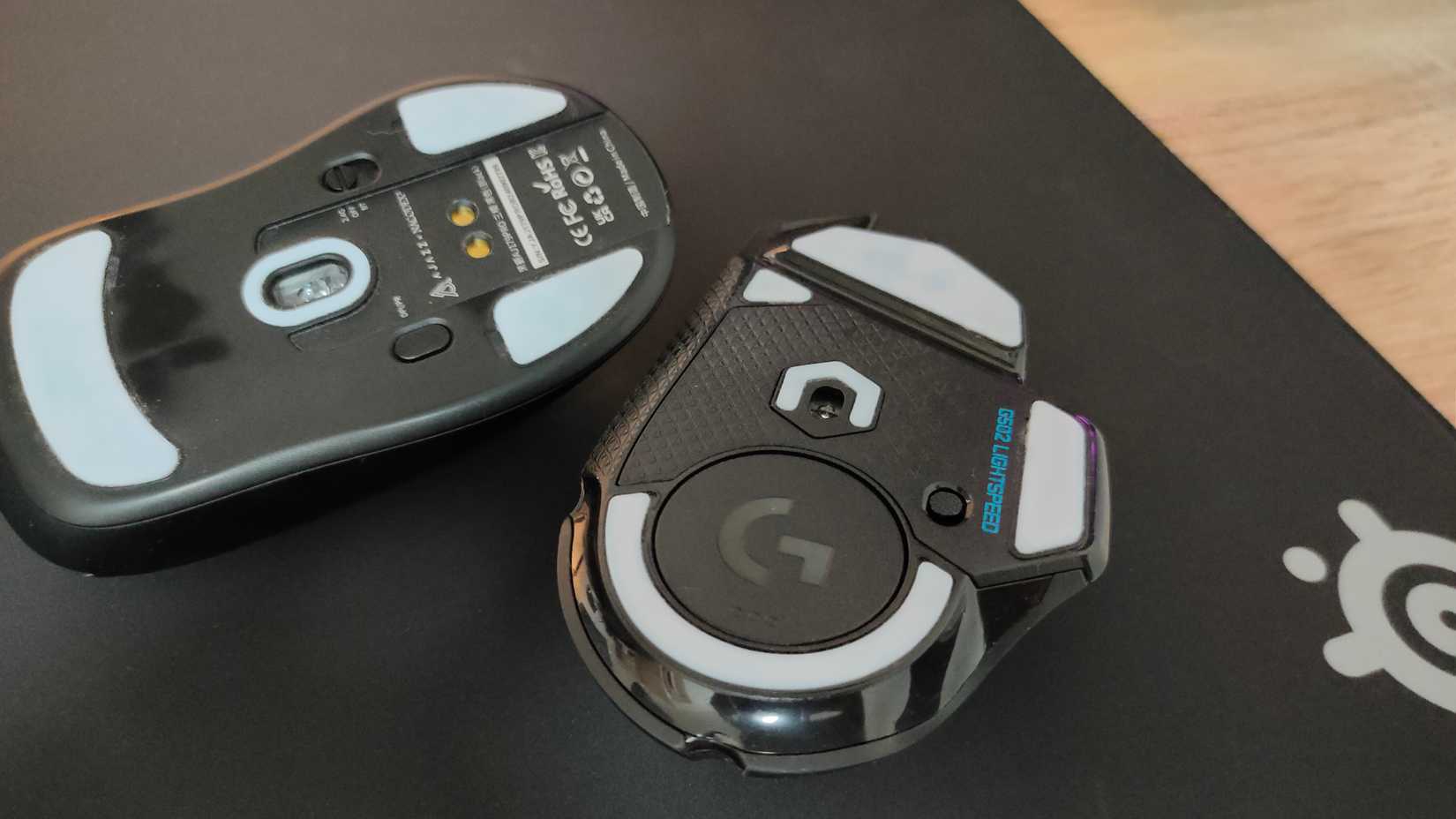 Custom mouse skates on the underside of the Logitech G502 Lightspeed and Ajazz AJ 179 Pro gaming mouse.