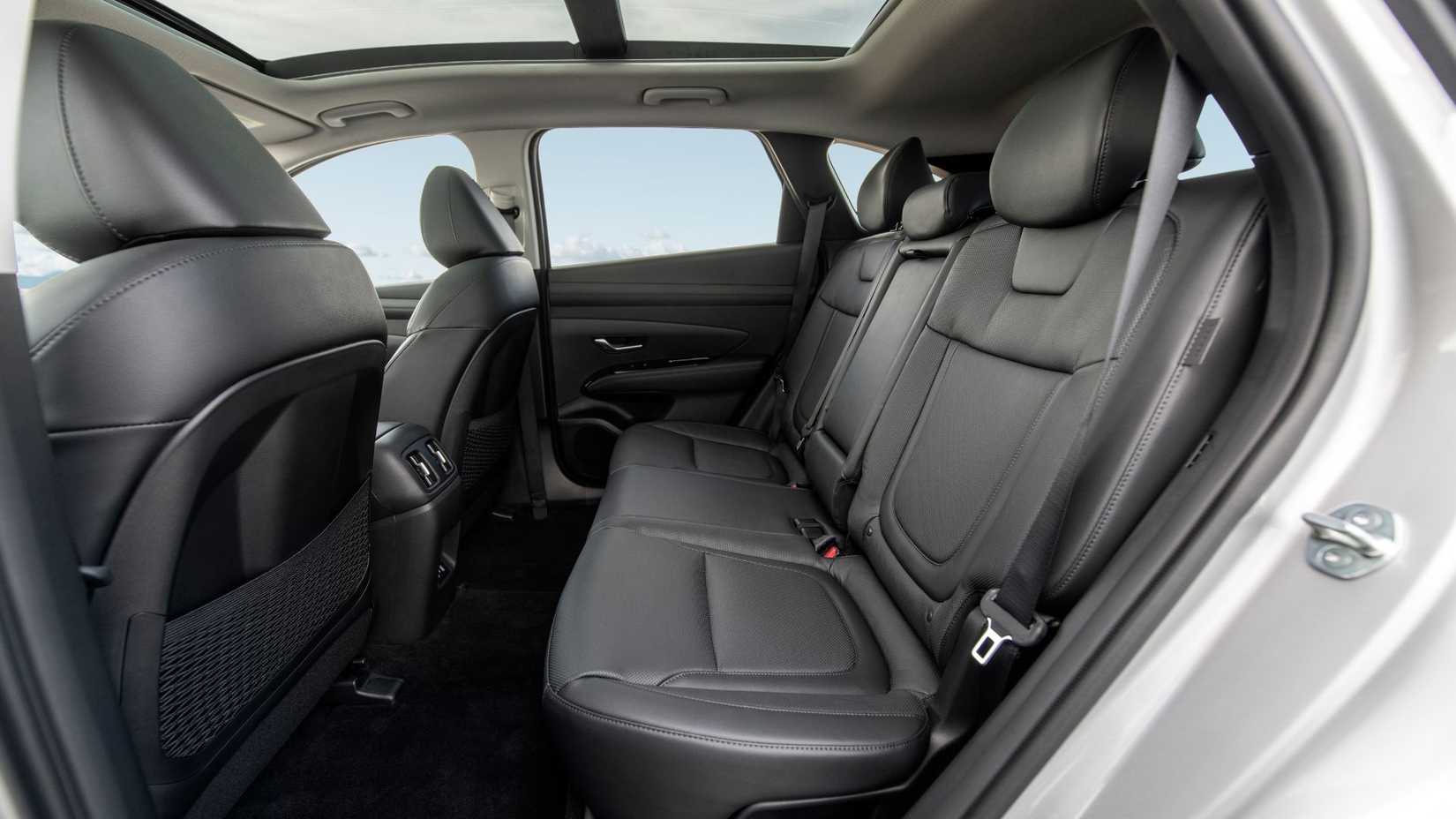Shot of inside the cabin of a 2026 Hyundai Tucson PHEV, showing the rear black leather seats.