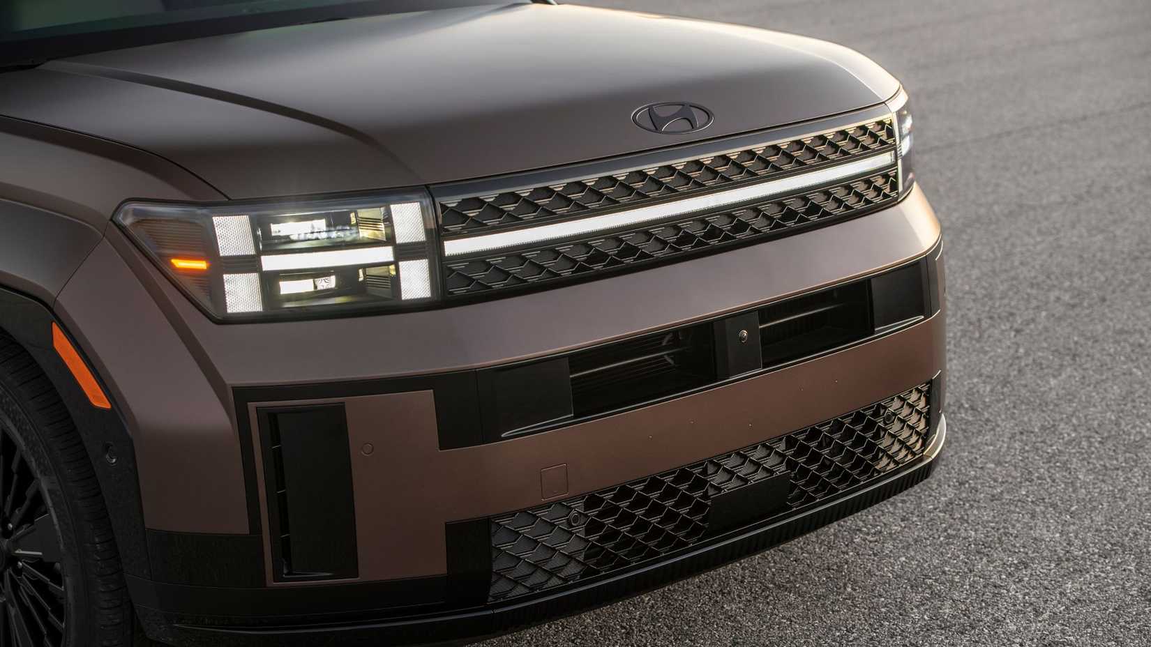 Close-up of the front of the bronze 2025 Hyundai Santa Fe Hybrid.